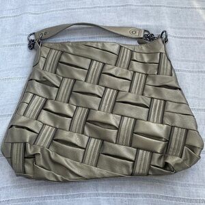Olivia and Joy pewter hand bag with zipper embellishments.